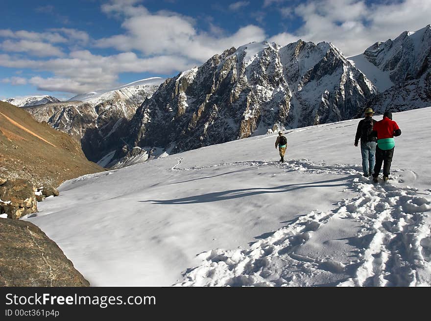 Men, mountains and glacier.