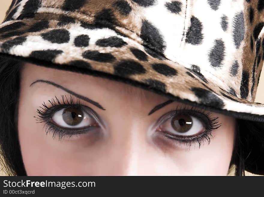 Beautiful brunette young woman with hat of leopard