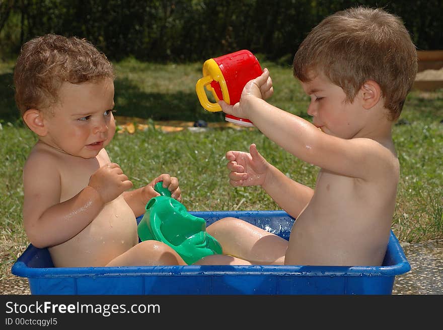 Two boys playing with water. Two boys playing with water