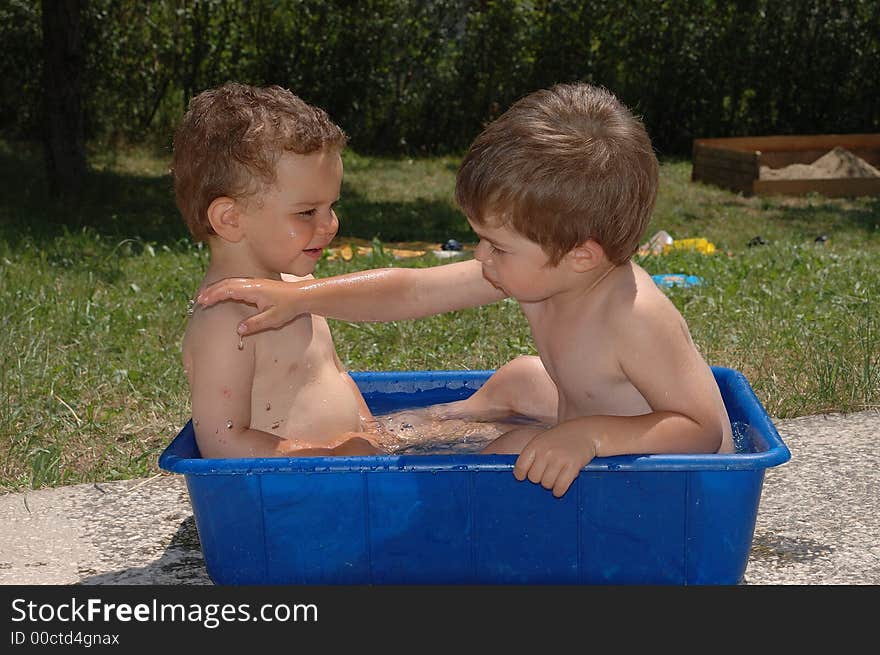 Two boys playing with water. Two boys playing with water