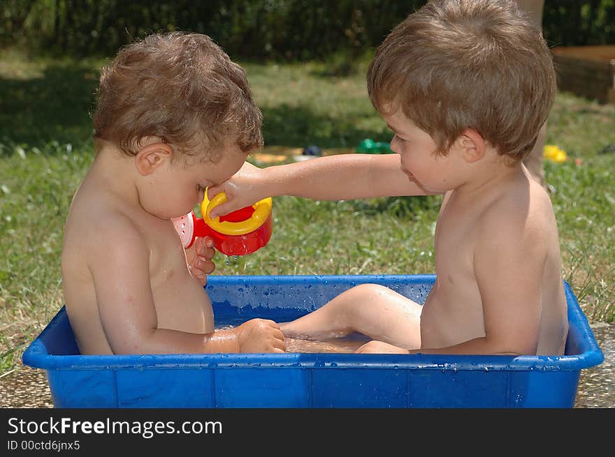 Two boys playing with water. Two boys playing with water