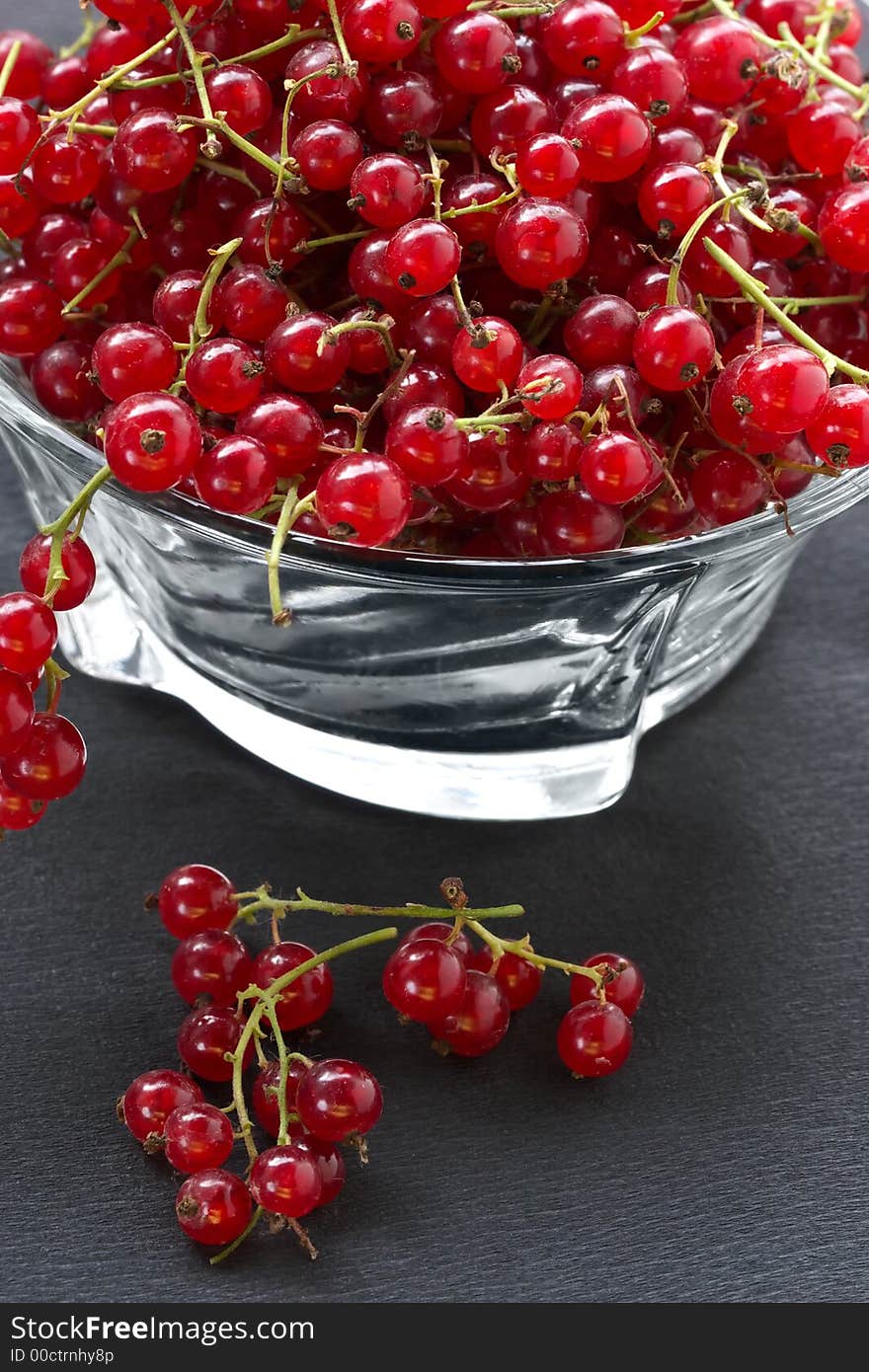 Red currant on the table in a shadow of suburban site