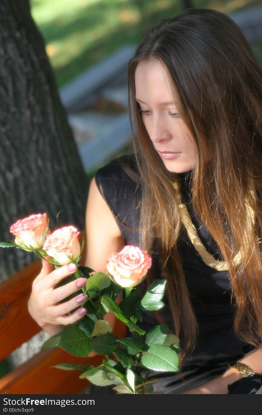 Girl with roses in park. Girl with roses in park