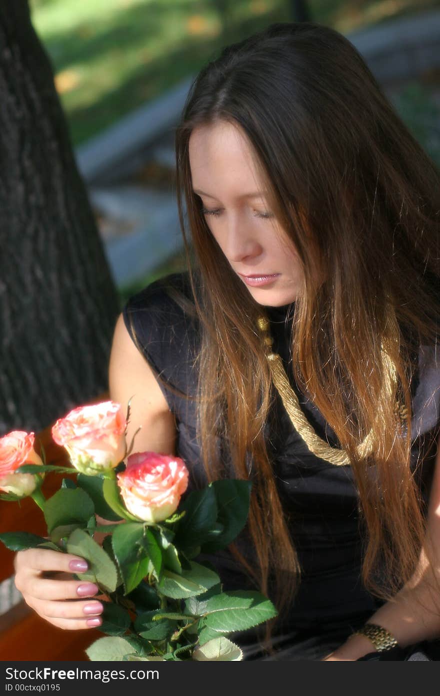 Girl with roses in park