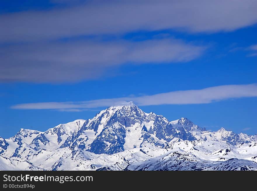 Snowed mountainrange surrounded by clouds. Snowed mountainrange surrounded by clouds