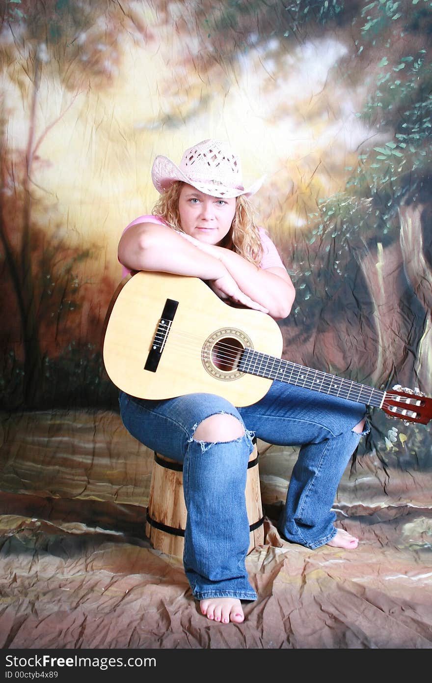 A country woman and her acoustic guitar. A country woman and her acoustic guitar.