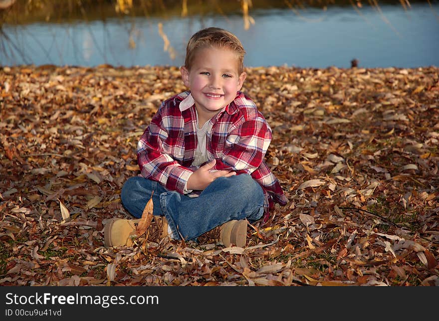 A boy in red at the lake