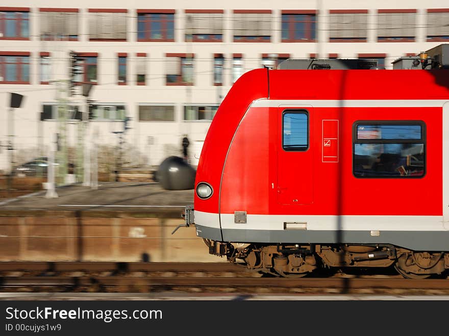 Speeding commuter train (S-Bahn) in Munich, Germany. Slight motion-blur of background.