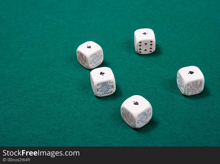 Poker dices at a poker game table. Shallow depth of field. Poker dices at a poker game table. Shallow depth of field