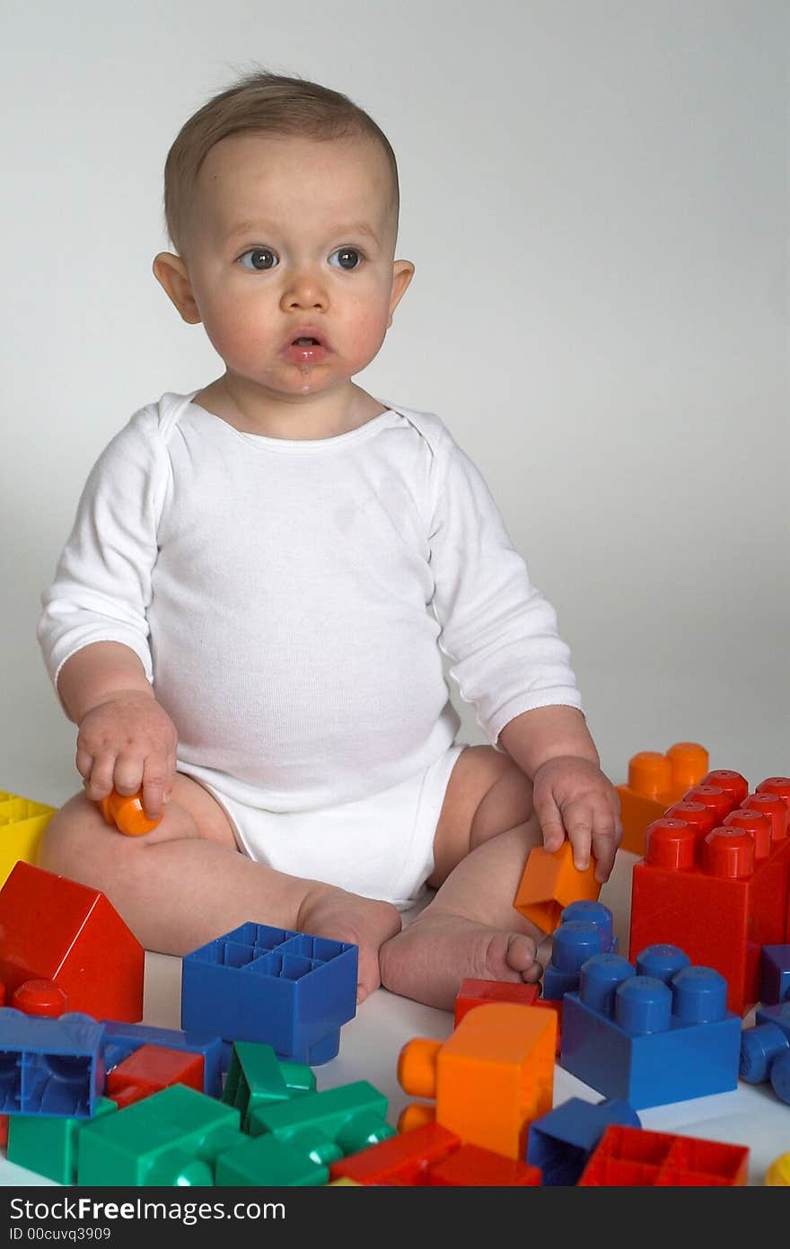 Image of cute baby playing with colorful building blocks. Image of cute baby playing with colorful building blocks