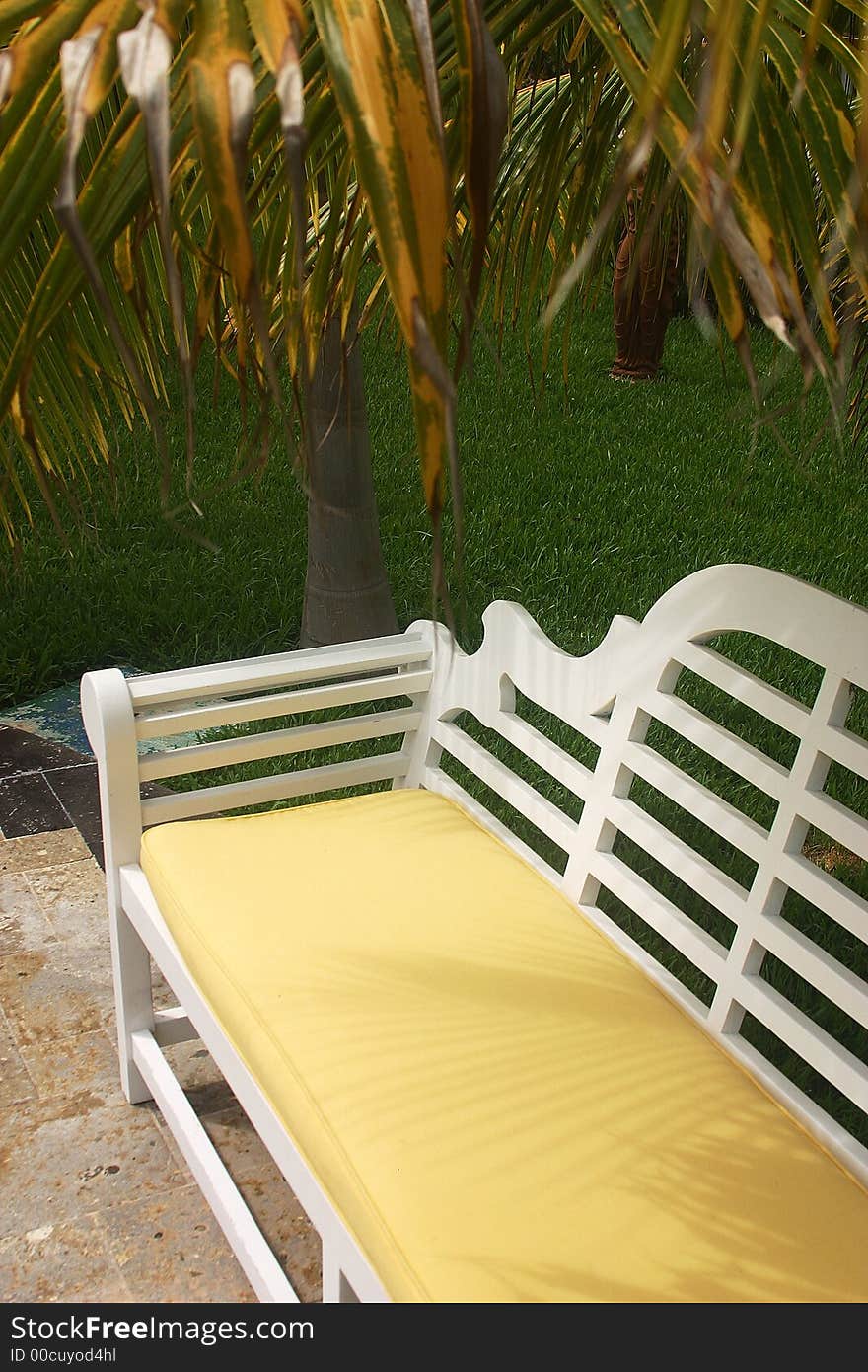 White bank or bench in a hotelgarden at the Riviera maya. White bank or bench in a hotelgarden at the Riviera maya