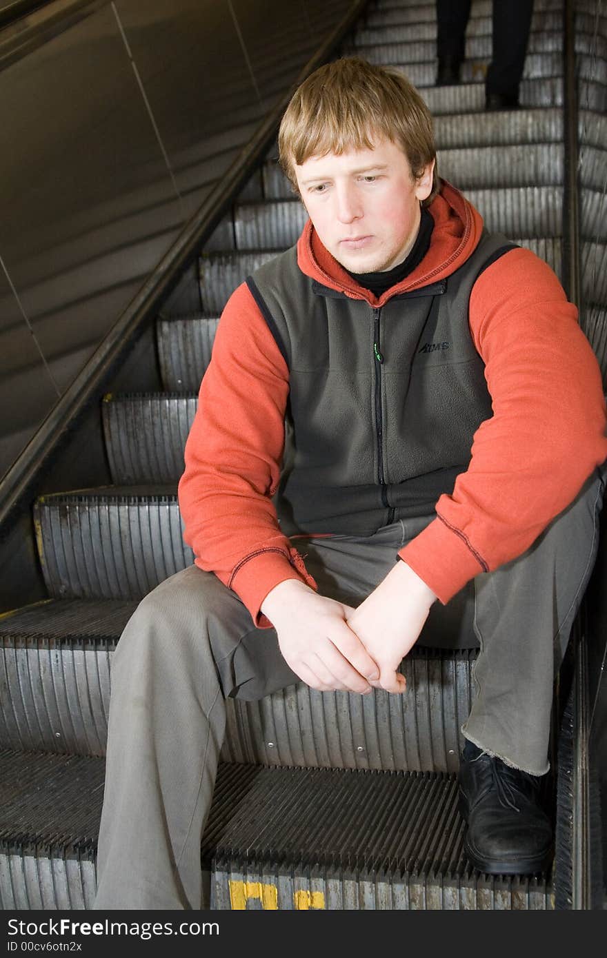 Man at Moscow subway. Sittting on steps of escalator. Man at Moscow subway. Sittting on steps of escalator