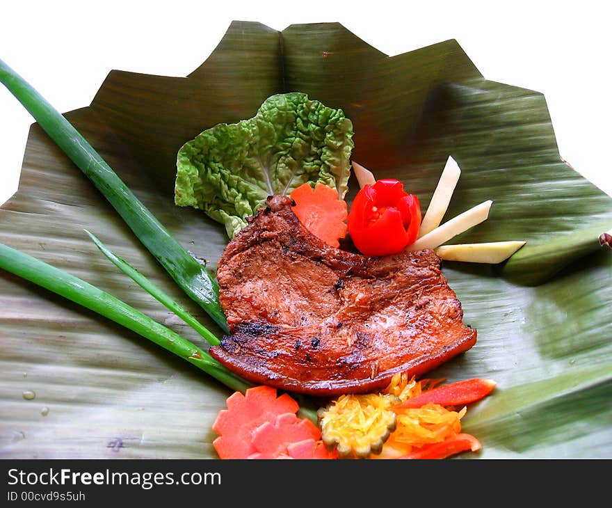 Delicious pork chop served on a banana leaf. Delicious pork chop served on a banana leaf