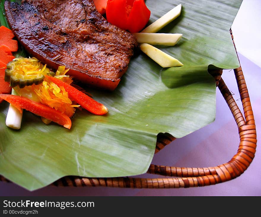 Delicious pork chop served on a banana leaf. Delicious pork chop served on a banana leaf