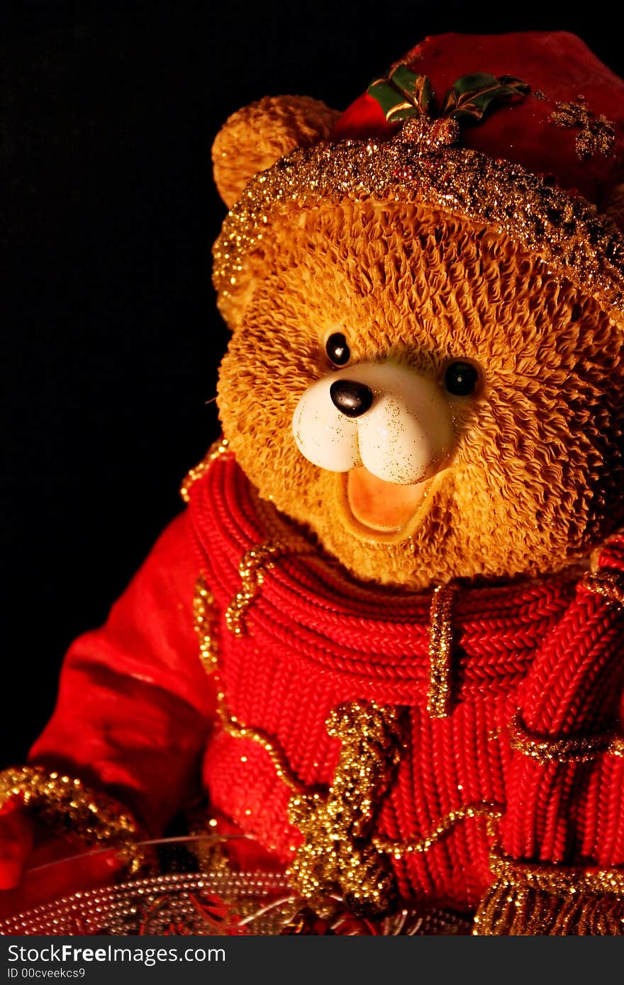 Teddy bear in winter, on black background