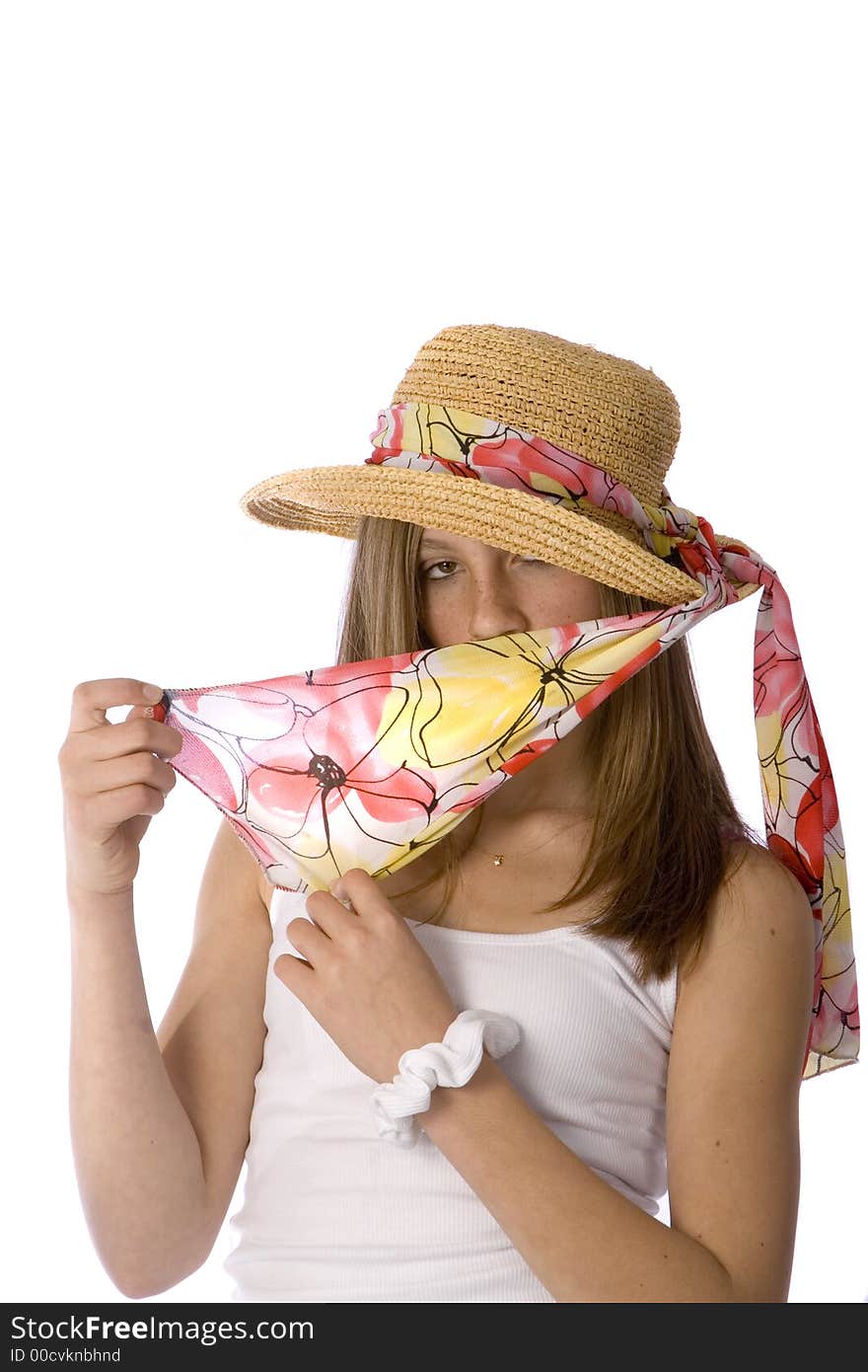 Pretty teenager peeking out from behind a scarf while wearing a hat. Pretty teenager peeking out from behind a scarf while wearing a hat