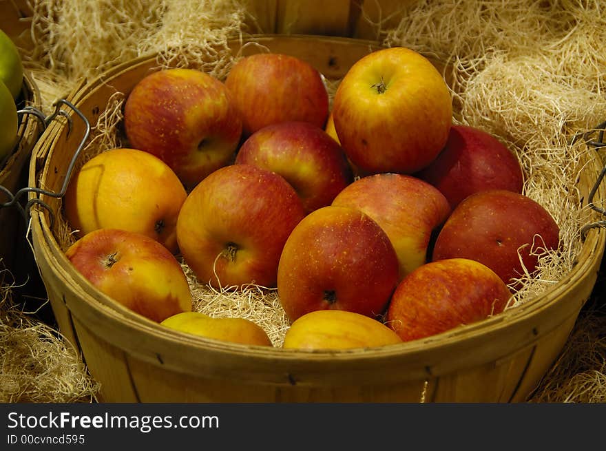 A bunch of apples in a wooden basket. A bunch of apples in a wooden basket