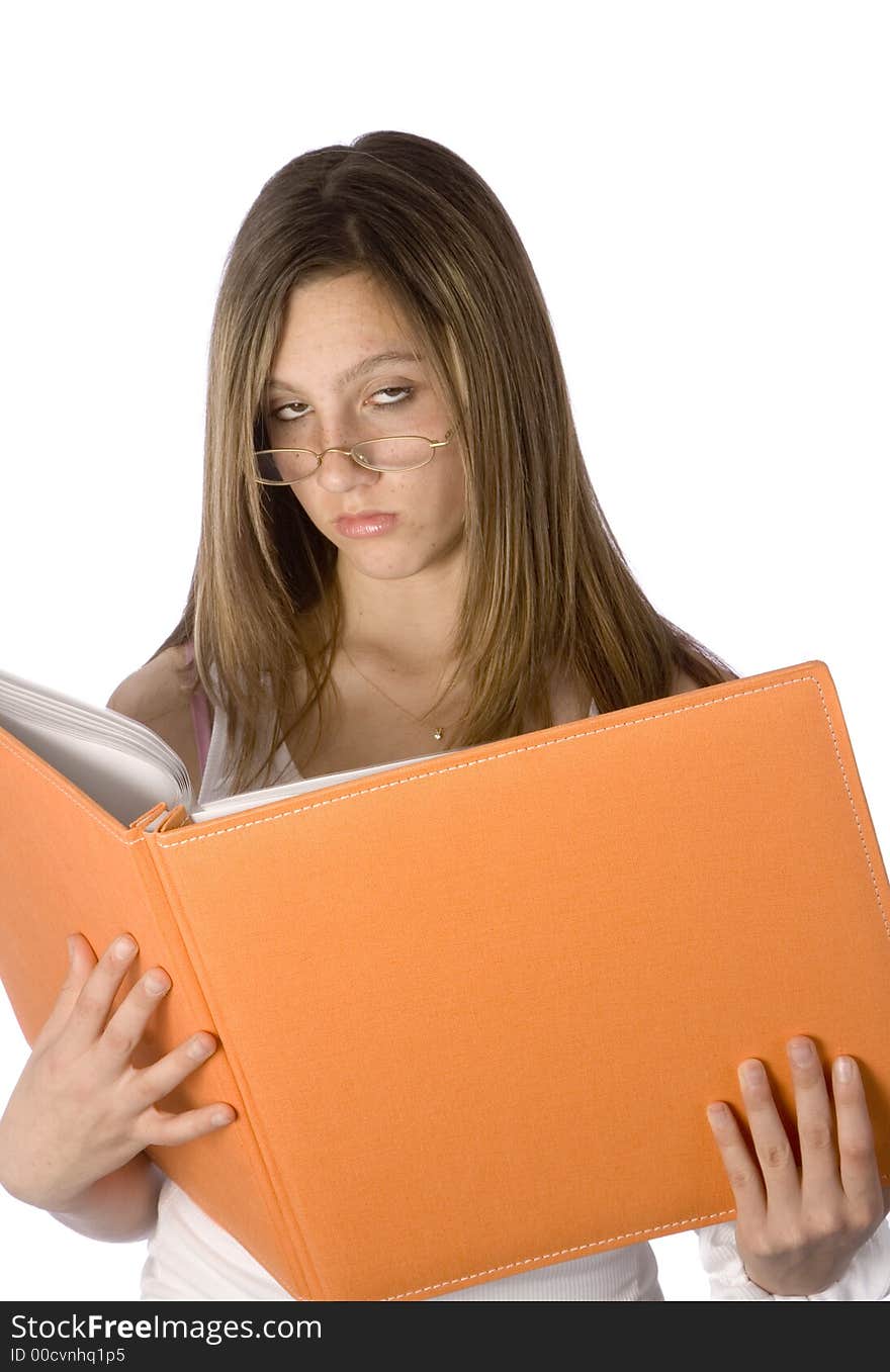 Teenager looking up from orange book rolling her eyes through glasses. Teenager looking up from orange book rolling her eyes through glasses