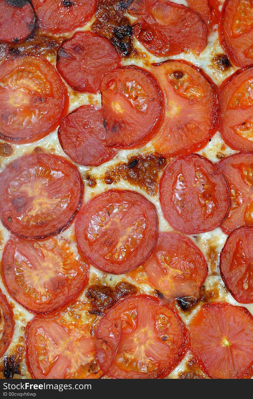 Close up of fresh tomatoes and cheese pizza topping. Close up of fresh tomatoes and cheese pizza topping.