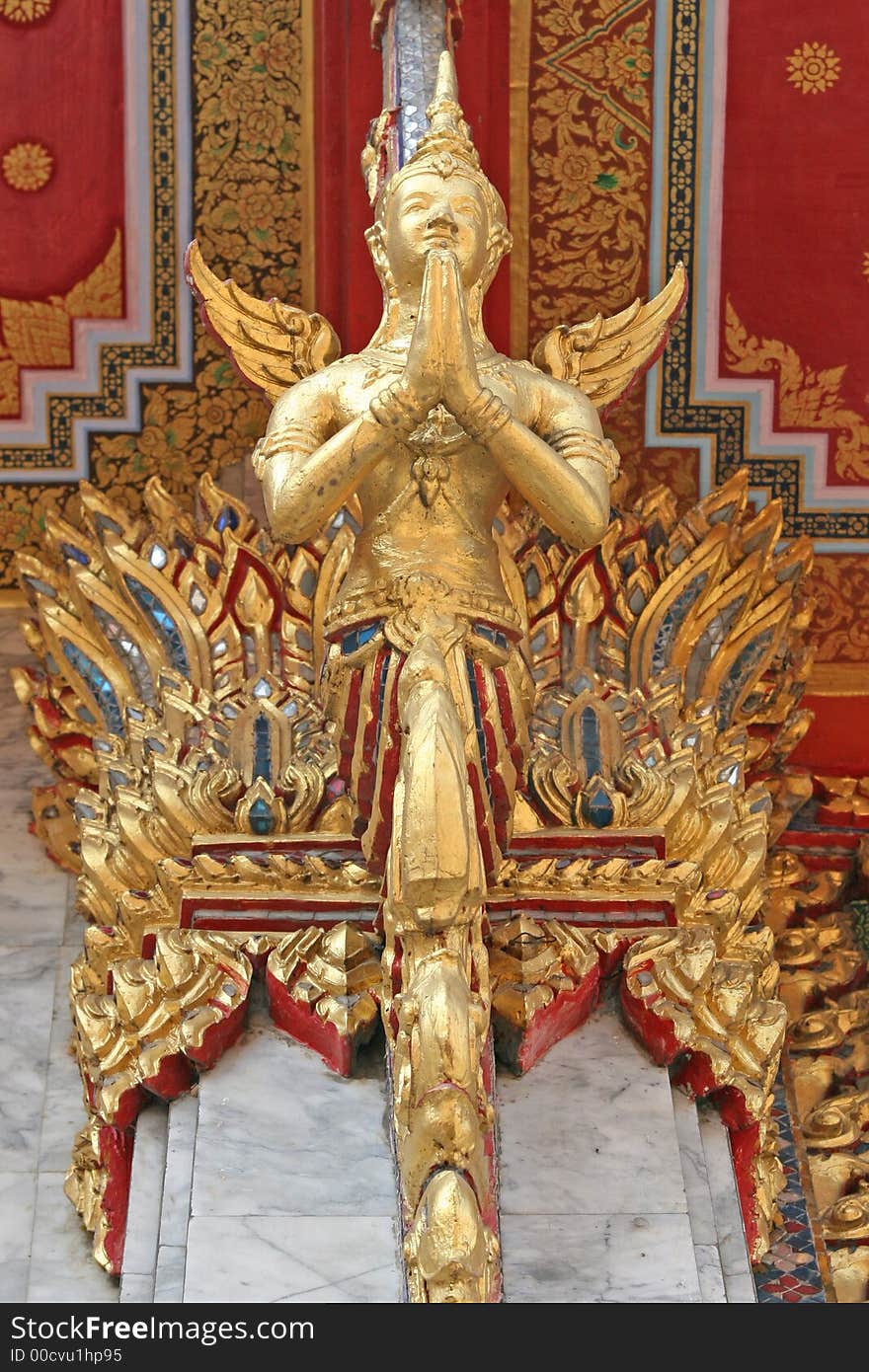 Decorative praying statue on a Chinese Buddhist temple