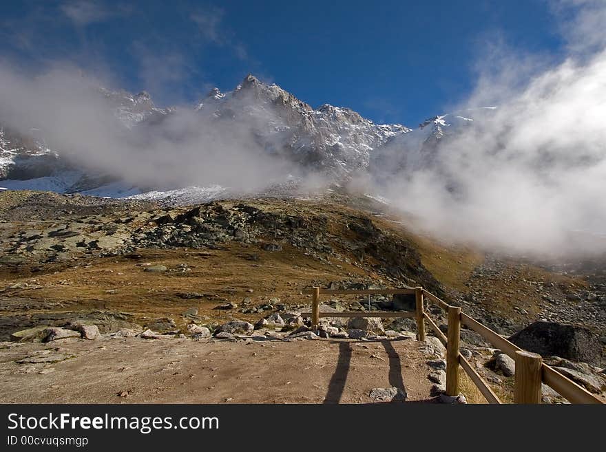 A panorama of Mont Blanc in easy clouds, and a high-mountainous meadow. A panorama of Mont Blanc in easy clouds, and a high-mountainous meadow