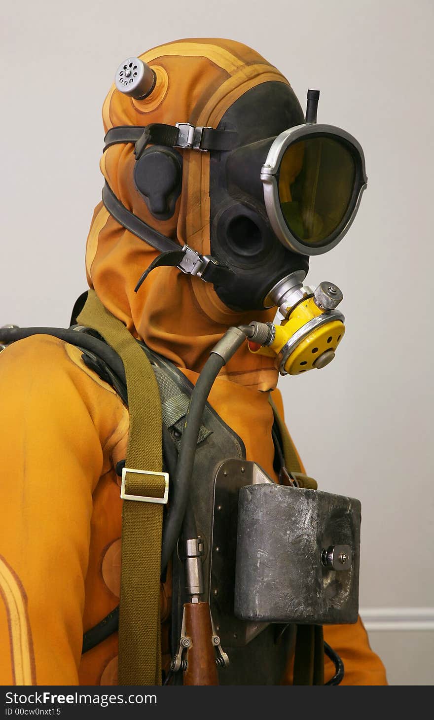 The mannequin is dressed in a orange diving suit with a cargo, hoses and a rubber mask