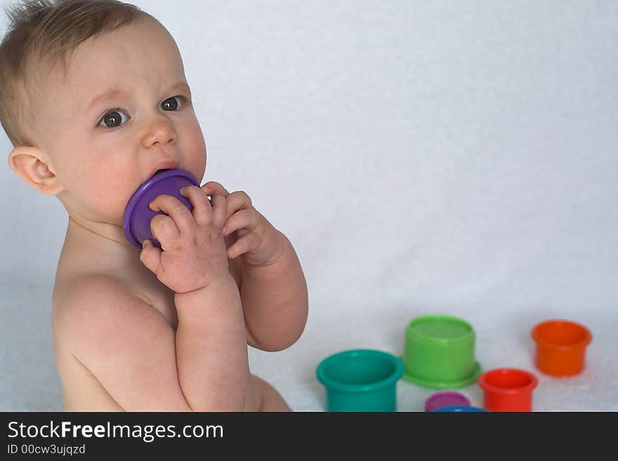 Image of adorable baby playing with stacking cups. Image of adorable baby playing with stacking cups