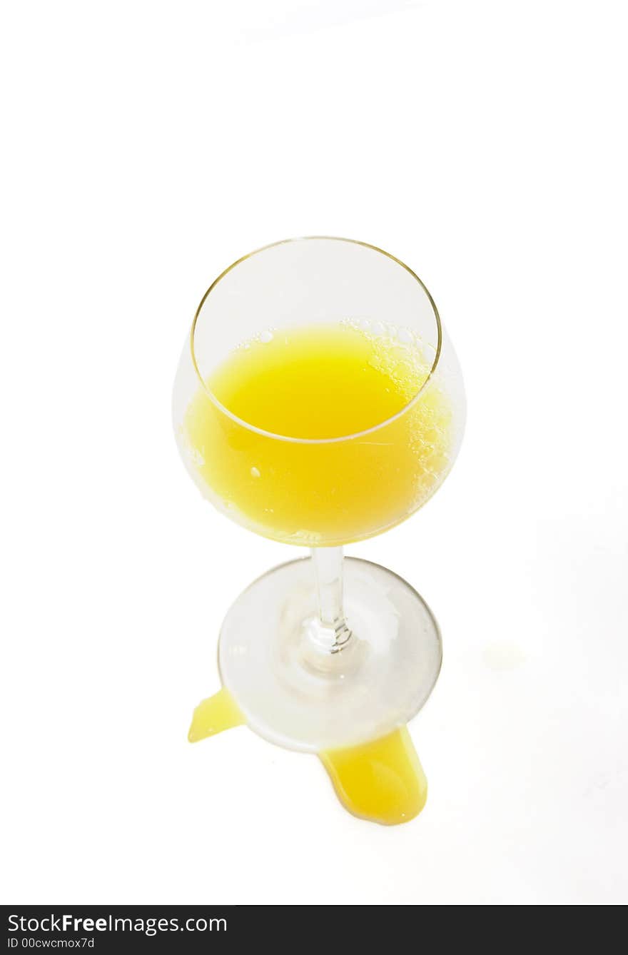 Fresh brightly orange juice in glass on a white background