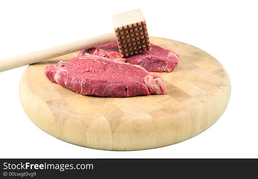 Tenderized Steak on a chopping board on a white background. Tenderized Steak on a chopping board on a white background