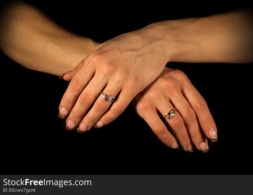 Female hands isolated on black, tungsten lighting used. Female hands isolated on black, tungsten lighting used