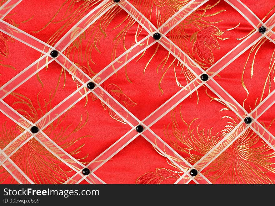 Close-up of a red memo board with white band and black button