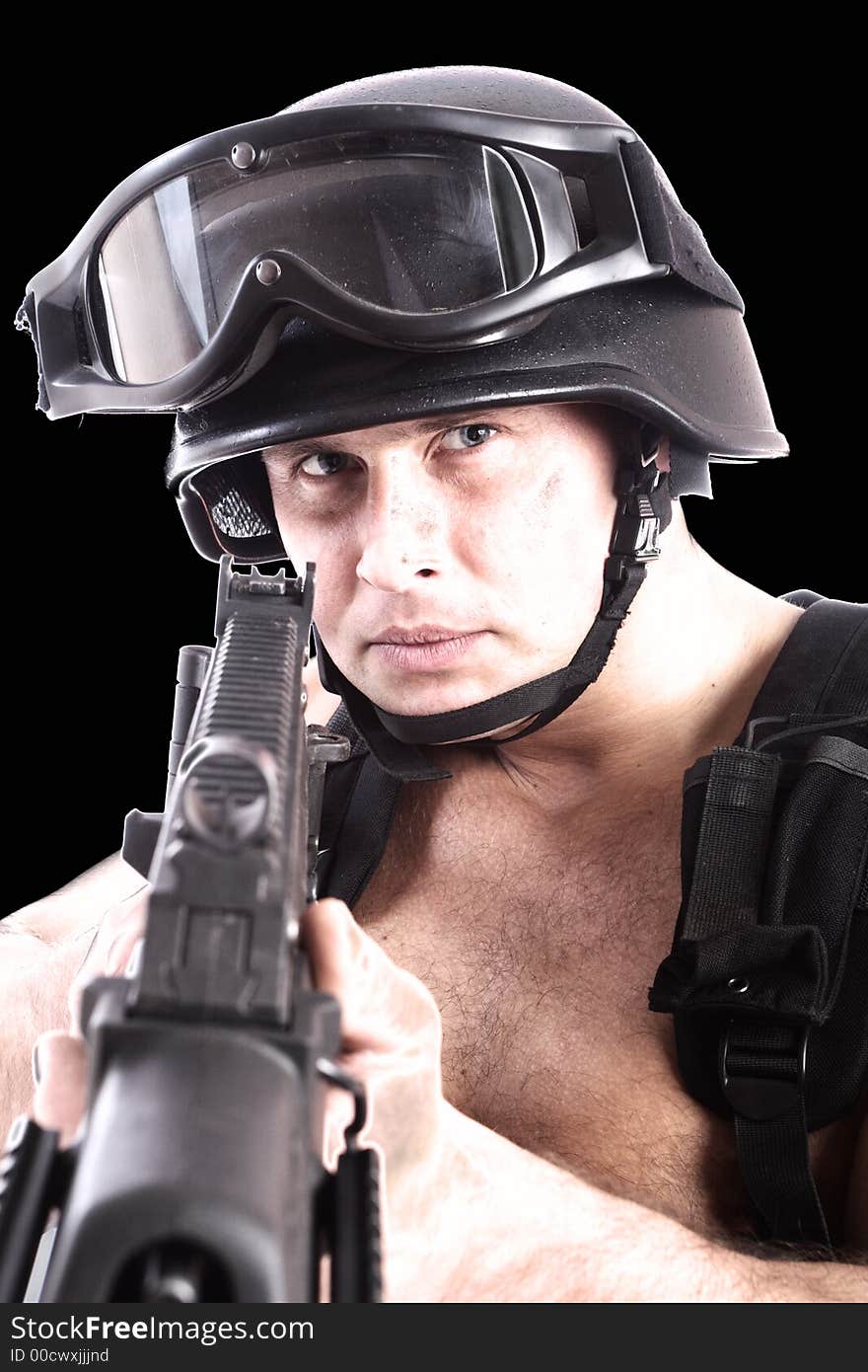 Shot of a soldier holding gun. Uniform conforms to special services(soldiers) of the NATO countries. Shot in studio. Isolated on white. Shot of a soldier holding gun. Uniform conforms to special services(soldiers) of the NATO countries. Shot in studio. Isolated on white.