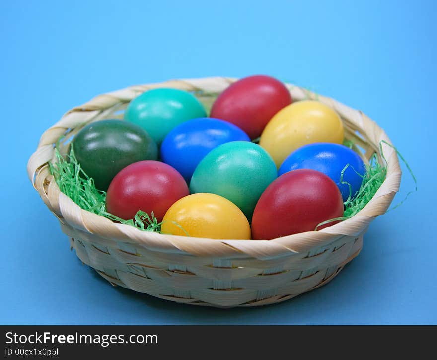 Colored eggs in basket