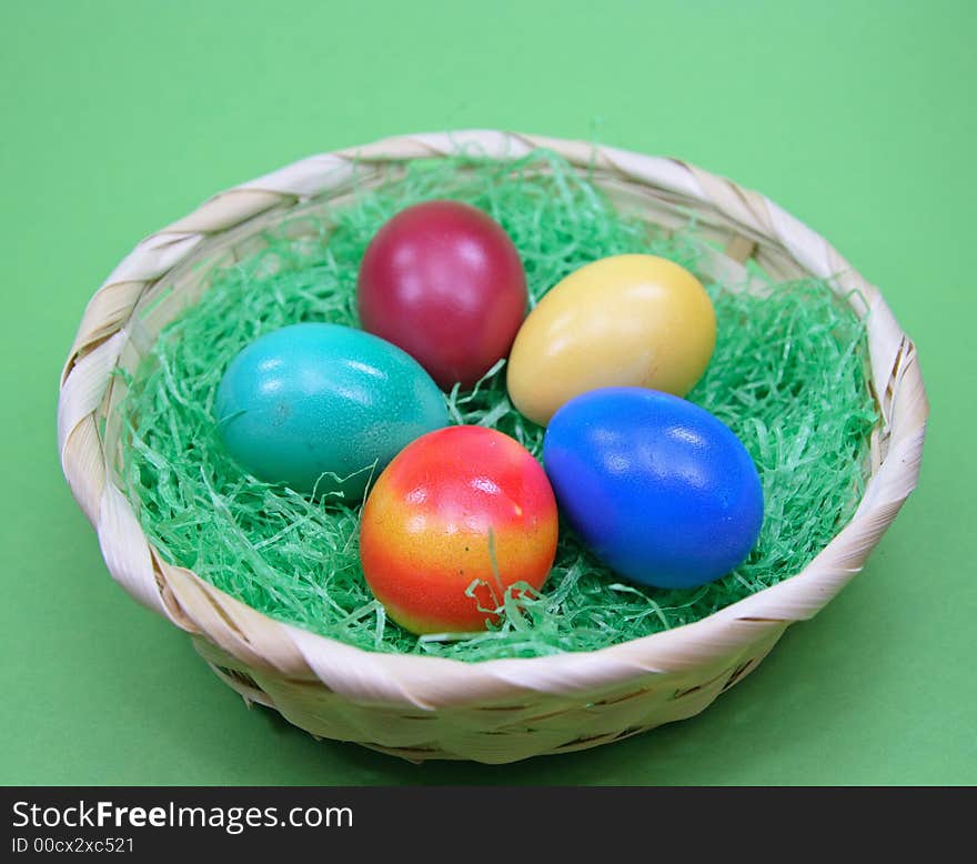 Colored eggs in basket