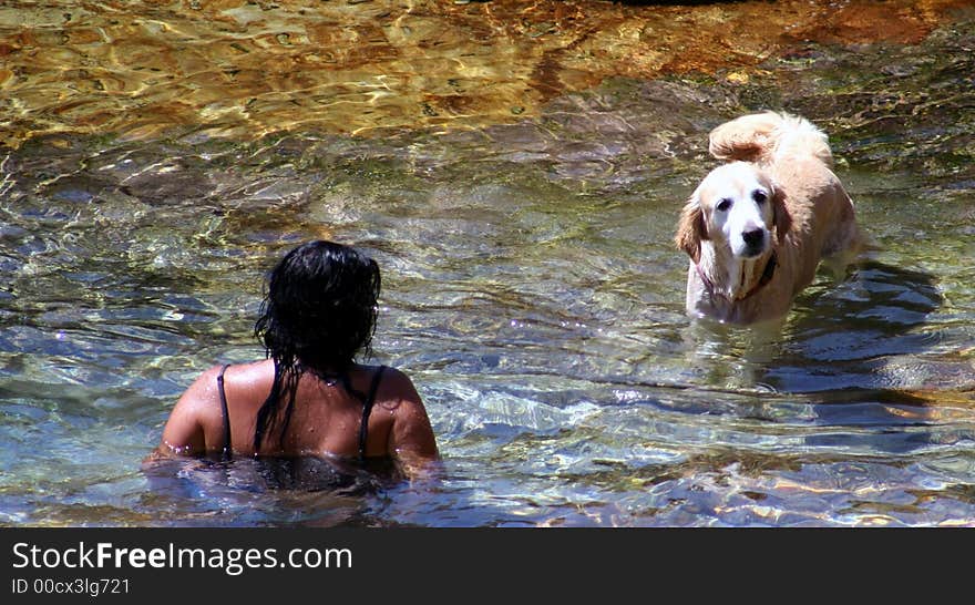 Woman and her dog swimming