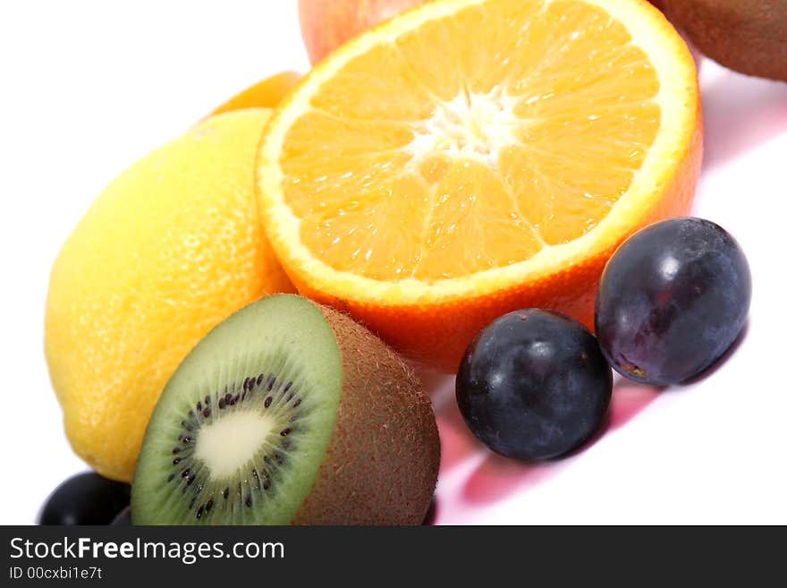 Sliced orange and other fruits on the white background. Sliced orange and other fruits on the white background