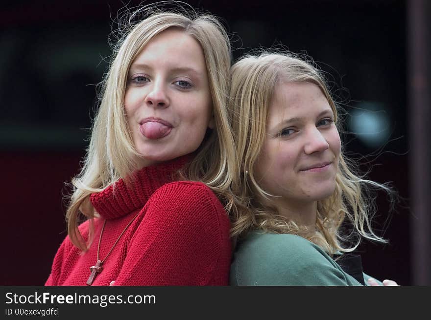 Two young blond women standing on stairs. Two young blond women standing on stairs