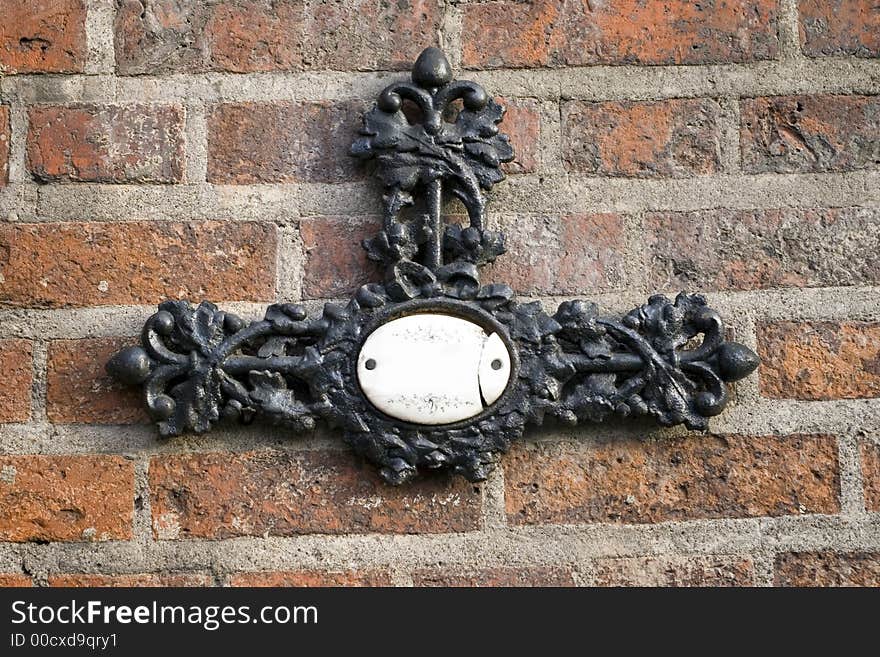 Metal Cross On A Brick Wall