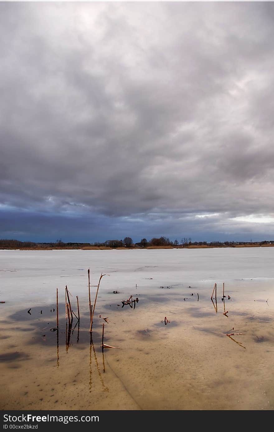 Stormy clouds over a frozen lake. Stormy clouds over a frozen lake