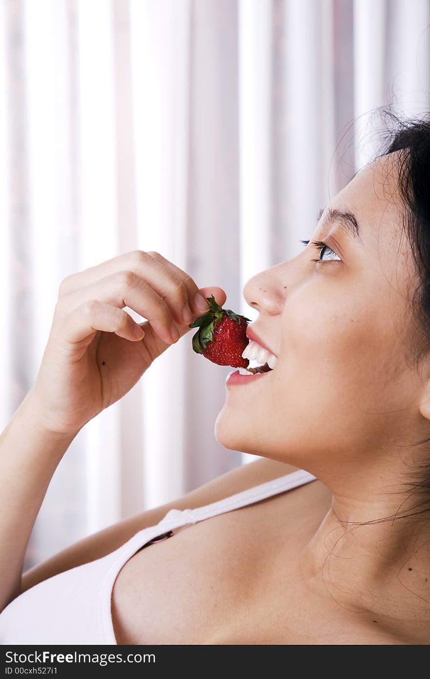 Pregnant woman enjoying her strawberry. Pregnant woman enjoying her strawberry