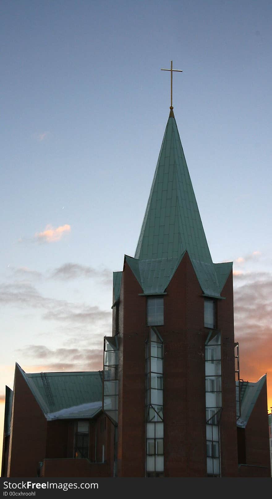 Catholic church with a cross on a background of the evening sky. Catholic church with a cross on a background of the evening sky.