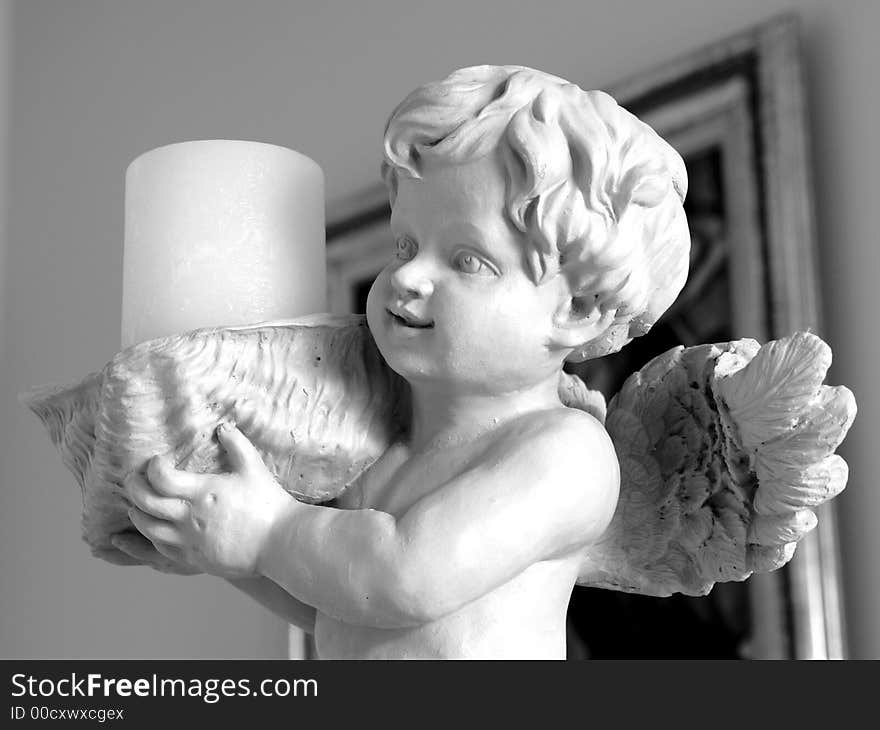 Cherub statue candle holder in black and white. Cherub statue candle holder in black and white