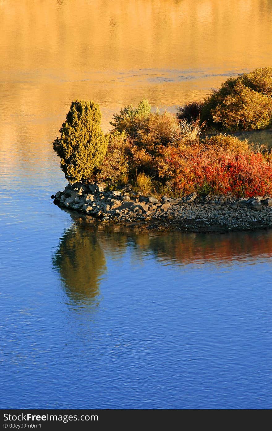 Reflection of trees in river water with island. Reflection of trees in river water with island