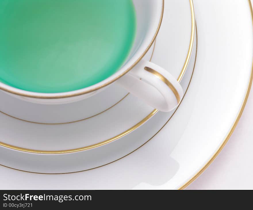 Green Herbal tea in a tea cup on saucer. Green Herbal tea in a tea cup on saucer