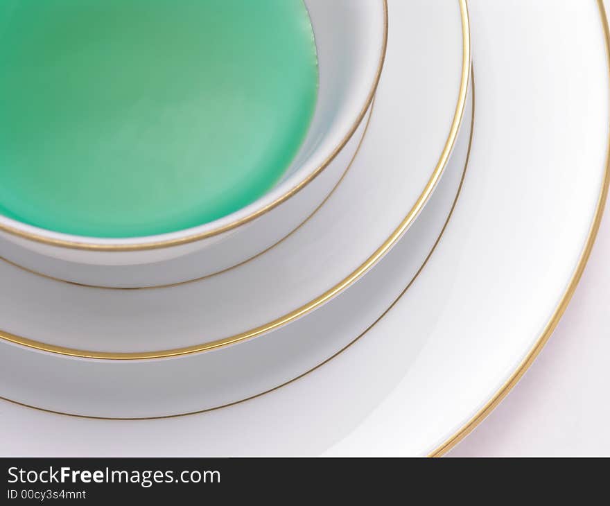 Green Herbal tea in a tea cup on saucer. Green Herbal tea in a tea cup on saucer