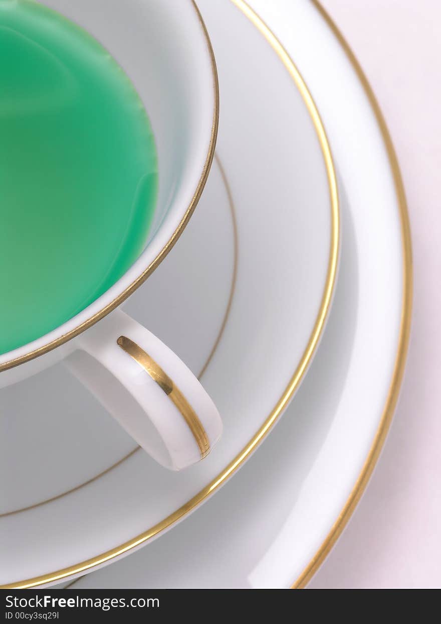 Green Herbal tea in a tea cup on saucer. Green Herbal tea in a tea cup on saucer