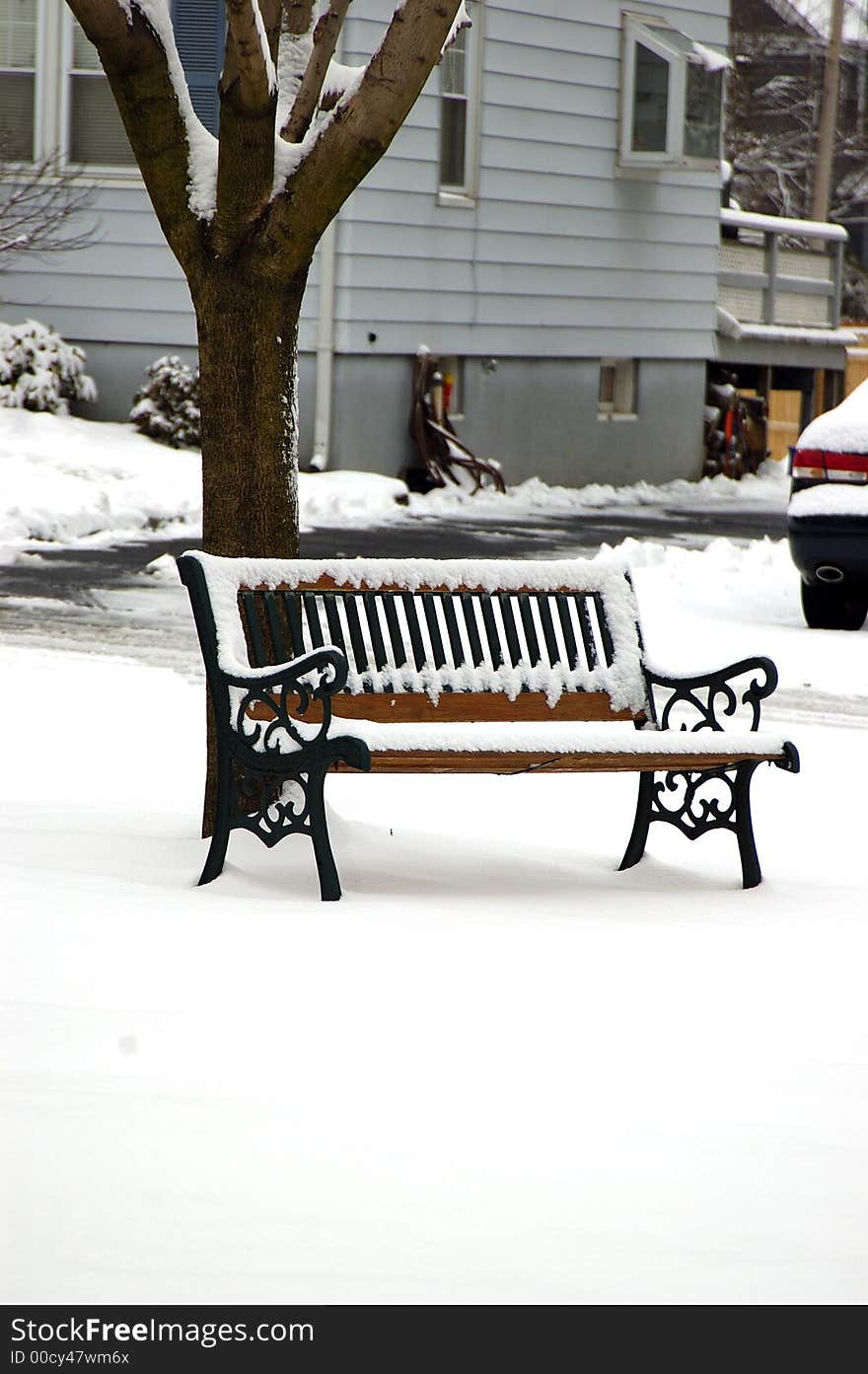 Snow on the wooden bench after a wintry blast