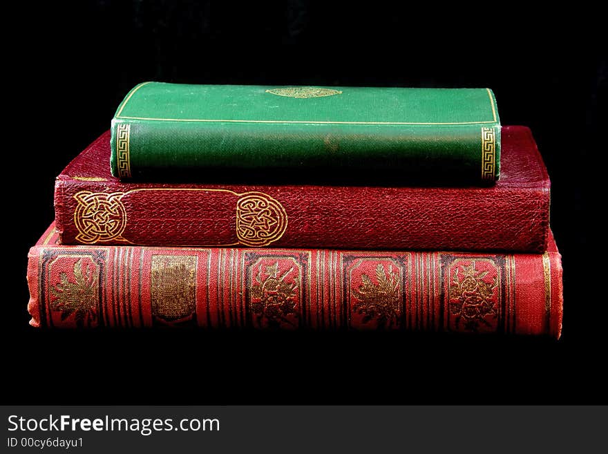 Stack of antique books against black background