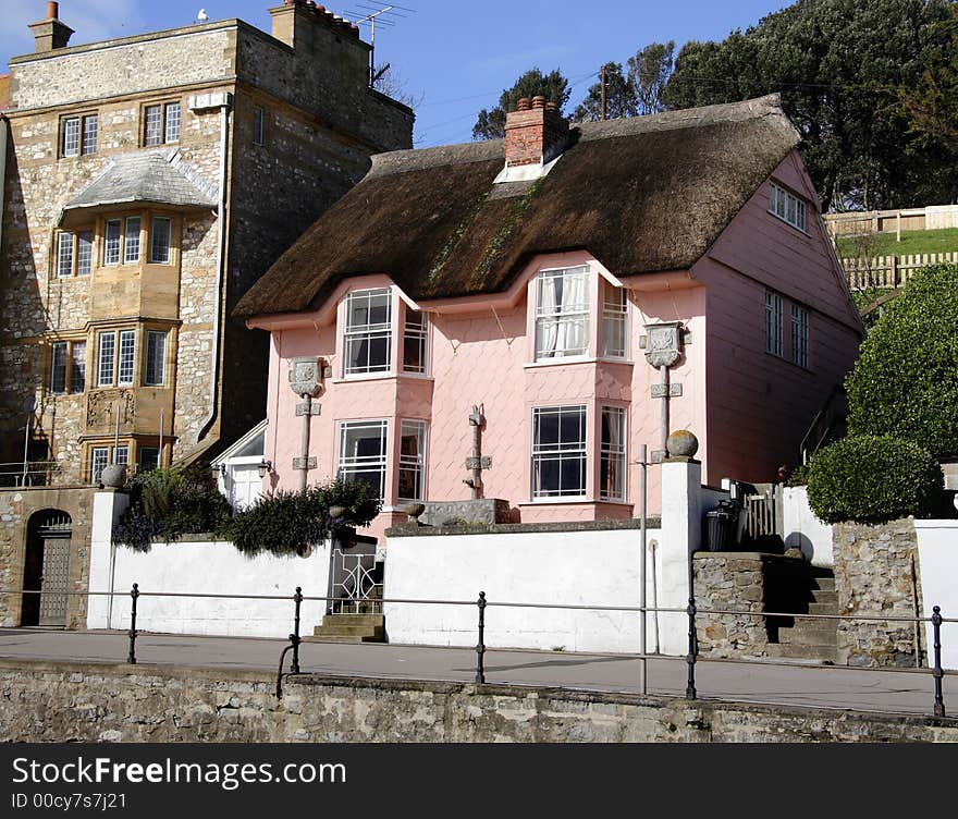 Pretty Pink Thatched Seaside House on the Promenade of an English Coastal resort. Pretty Pink Thatched Seaside House on the Promenade of an English Coastal resort