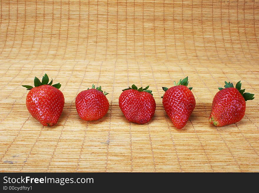 Big red strawberries on a doormat